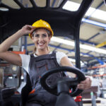 professional female industrial driver operating forklift machine factory s warehouse