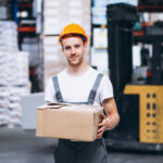 young man working warehouse with boxes